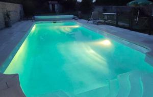 a swimming pool lit up at night at Nice Home In Boissy Le Châtel With Swimming Pool in Boissy-le-Châtel