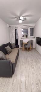 a living room with a couch and a table at Apartament Ziemia Kłodzka in Kłodzko