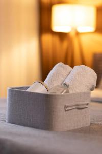 a suitcase sitting on a bed with towels at Prime space in Pristina