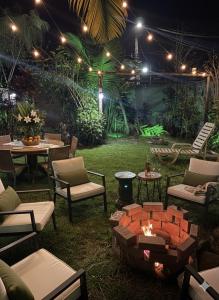 a patio with a fire pit and tables and chairs at Casa Luke Paraty in Paraty