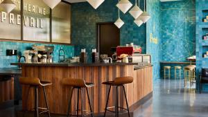 a bar in a restaurant with two stools at Midtown Luxury with Skyline Views in Atlanta