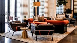 a living room with couches and chairs on a rug at Midtown Luxury with Skyline Views in Atlanta