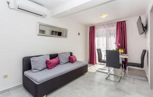 a living room with a couch and a table at Amazing Apartment In Baska With Swimming Pool in Draga Bašćanska