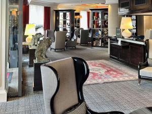 a hotel lobby with chairs and a waiting room at Park Hotel Grenoble - MGallery Collection in Grenoble +106 photos