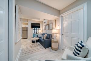 a living room with a blue couch and a table at Serenity at the Sea in Tybee Island