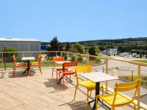 a group of tables and chairs on a patio at ibis budget Epinal in Épinal