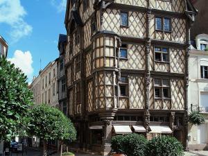 a large wooden building on a city street at Ibis Budget Angers Parc des Expositions in Saint-Sylvain-dʼAnjou