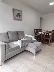 a living room with a couch and a table and chairs at Departamento sobre la costanera in Corrientes