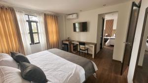 HuauraにあるBarón de Huaura Hotel Boutiqueのベッドとデスクが備わるホテルルームです。 +6枚の写真