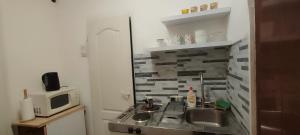 a small kitchen with a sink and a microwave at Republic square apartment in Belgrade