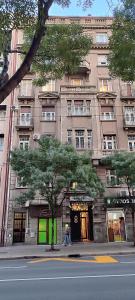a person walking in front of a large building at Republic square apartment in Belgrade