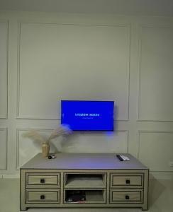 a tv on top of a dresser in a room at Luxury Lodge in Rawalpindi