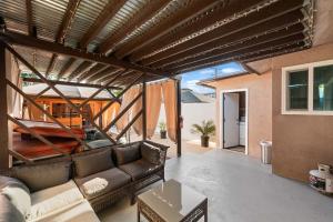 a living room with a couch and a table at Spacious 4BR Retreat in Pomona with Sauna and Hot Tub in Pomona