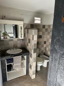 a bathroom with a sink and a toilet at Sierra Chica in Alta Gracia