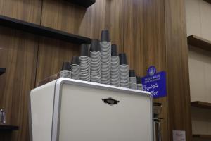 a podium with a stack of plates on it at راديكس ميلينيوم Radix Millennium in Ar Ruwanah +1 photo