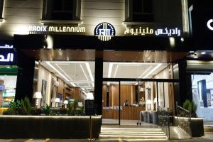 a building with a sign on the front of it at راديكس ميلينيوم Radix Millennium in Ar Ruwanah