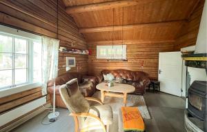 a living room with leather furniture and a table at 3 Bedroom Cozy Home In Mesnali in Olestad