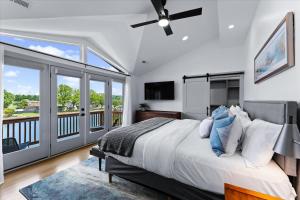 a bedroom with a large bed and a balcony at Elysian Shores w/Heated Pool & Optional Boat Rental in Mooresville +104 photos
