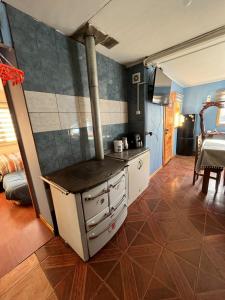 a kitchen with a stove top oven in a room at Cabaña en Cochrane in Cochrane