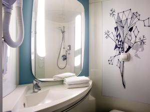a bathroom with a sink and a mirror at Ibis Budget Albi Centre in Albi