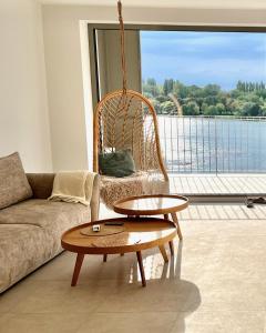 a living room with a couch and a table at Bluewave boho apartment Slnava in Banka