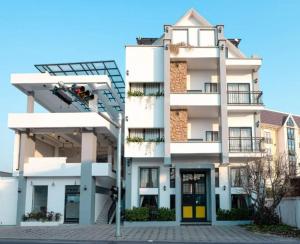 a white apartment building with a fire escape at Punleu Raksmey Boutique in Phumi Ta Phul