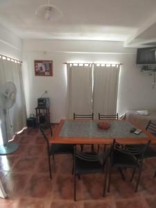 a living room with a wooden table and chairs at Nuestro Rinconcito in Villa Cura Brochero +32 photos