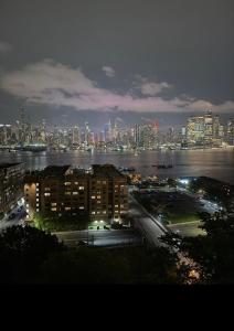 a view of a city at night with at Weehawken Apartment NYC Skyline in Weehawken