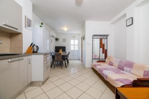 a living room with a couch and a kitchen at Apartments and rooms with parking space Senj - 5569 in Senj