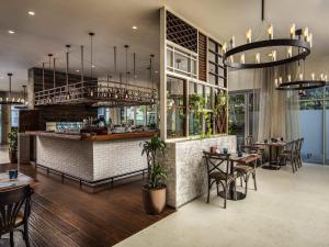 a restaurant with tables and chairs and a bar at Pullman Dubai Jumeirah Lakes Towers in Dubai