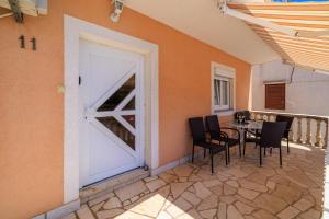 a patio with a table and chairs and a door at Apartments and rooms with parking space Senj - 5569 in Senj +33 photos