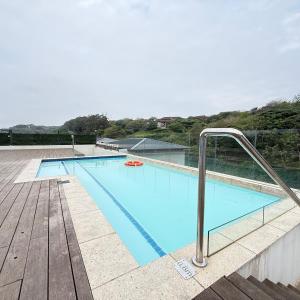 a large swimming pool on top of a building at Zimbali Ballito Vacation Apartment in Ballito