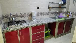 a kitchen counter with a stove and a sink at Bright Modern Apartment in Oualidia