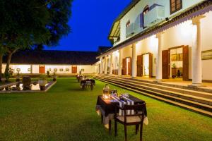 a courtyard with tables and chairs in a building at Tamarind Hill Galle in Galle