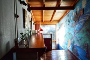 a dining room with a table and a wall with a mural at Patagonia Jazz Hostel in San Carlos de Bariloche