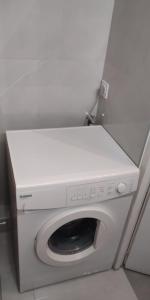 a washing machine in a corner of a room at Studio au centre-port in Cap d'Agde
