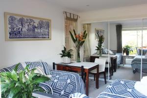 a living room with a couch and a table with plants at Byron Bay Nest Homestay in Byron Bay +13 photos