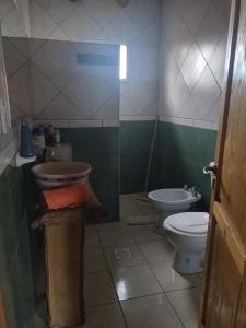 a bathroom with a sink and a toilet at Cabaña Hurú Zaha in La Consulta +19 photos