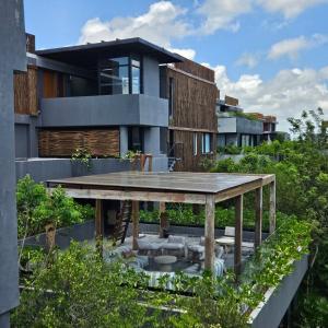 a modern house with a garden and a patio at Ride & Relax at Humana Tulum 2BR Free Bikes Near Beach in Tulum