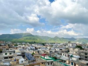 a city with buildings and mountains in the background at Luxury Apartment Guest House in Islamabad