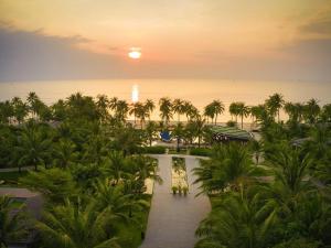 an aerial view of a resort with palm trees and the ocean at Novotel Phu Quoc Resort in Phu Quoc