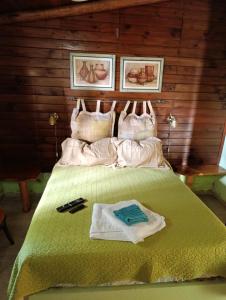 a bedroom with a bed with a green comforter at Cabatanti in Tanti +32 photos