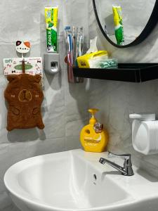 a bathroom with a sink and a mirror at J&Y Homestay Kluang in Kluang +7 photos