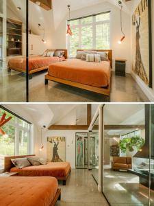 an orange bedroom with two beds and a large window at Escapade bien-être, en Estrie in Shefford