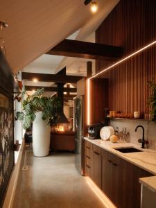 a kitchen with wooden cabinets and a potted plant at Escapade bien-être, en Estrie in Shefford +18 photos