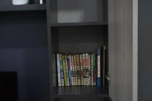 a book shelf with a bunch of books on it at J&Y Homestay Kluang in Kluang