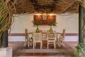 a dining room with a table and chairs at Conceptio in San Pedro Las Huertas +114 photos