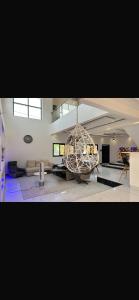 a large room with a large sculpture in the middle at Villa serenité lac rose avec cuisinier ,piscine et jacuzzi terrasse vue lac in Ouayembame +50 photos