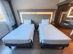 Postel nebo postele na pokoji v ubytování Novotel RJ Praia de Botafogo