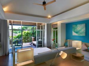 a living room with a couch and a ceiling fan at Pullman Phuket Panwa Beach Resort in Panwa Beach +194 photos
